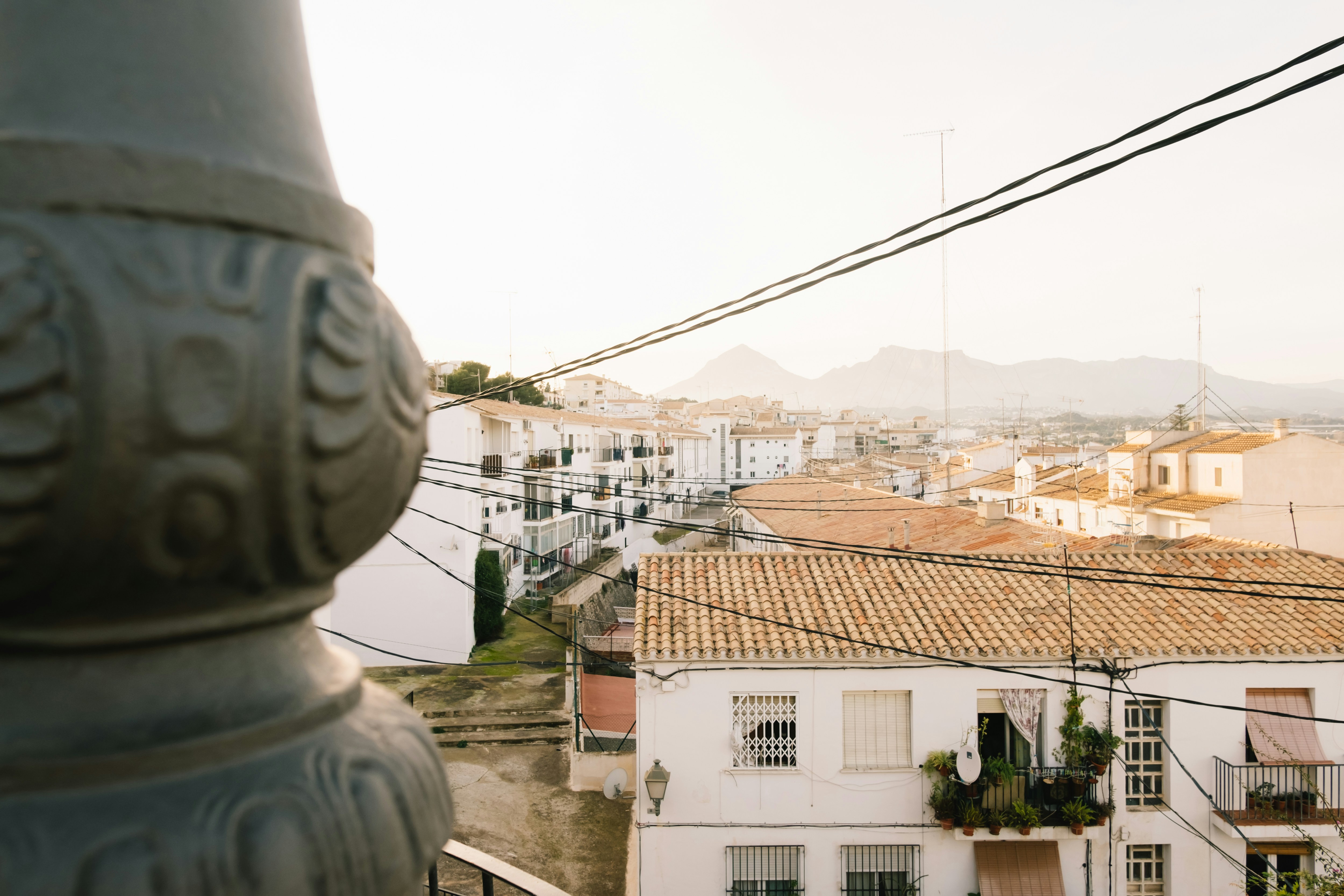 Landscape · A stunning top view of the Spanish city Altea. White mountain town. Brown rooftops and white houses in a soft sunset lig