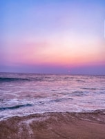 A calming landscape showcasing gentle waves at sunset.