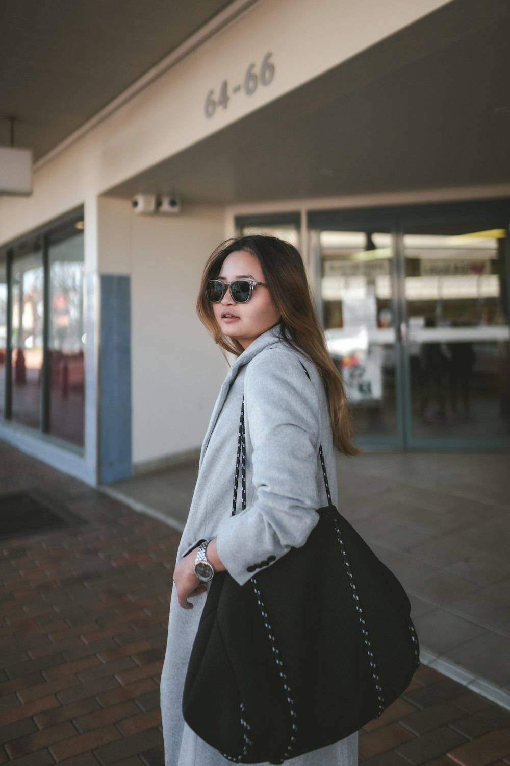 a woman is standing outside of a building