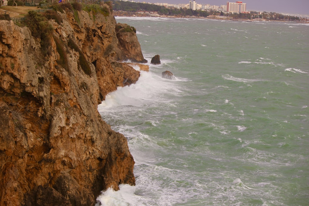waves crashing against a rocky cliff near the ocean