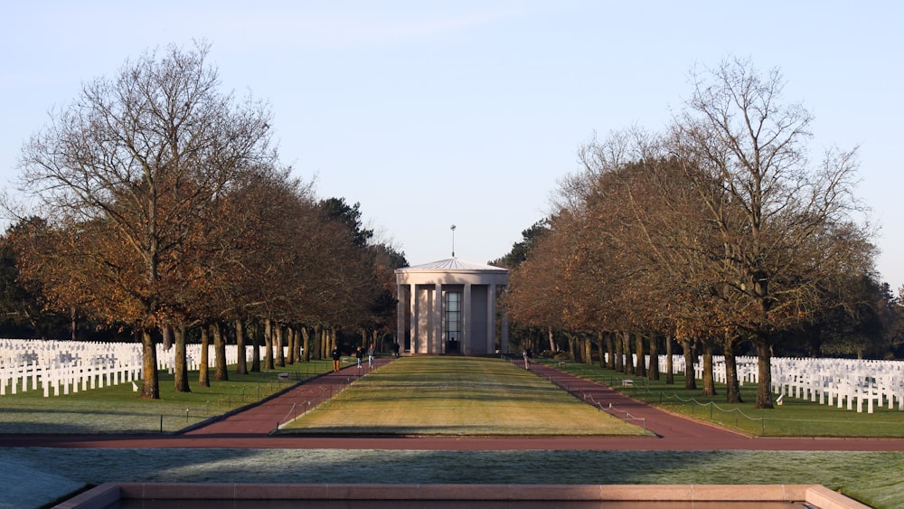 a view of a white building with trees in front of it