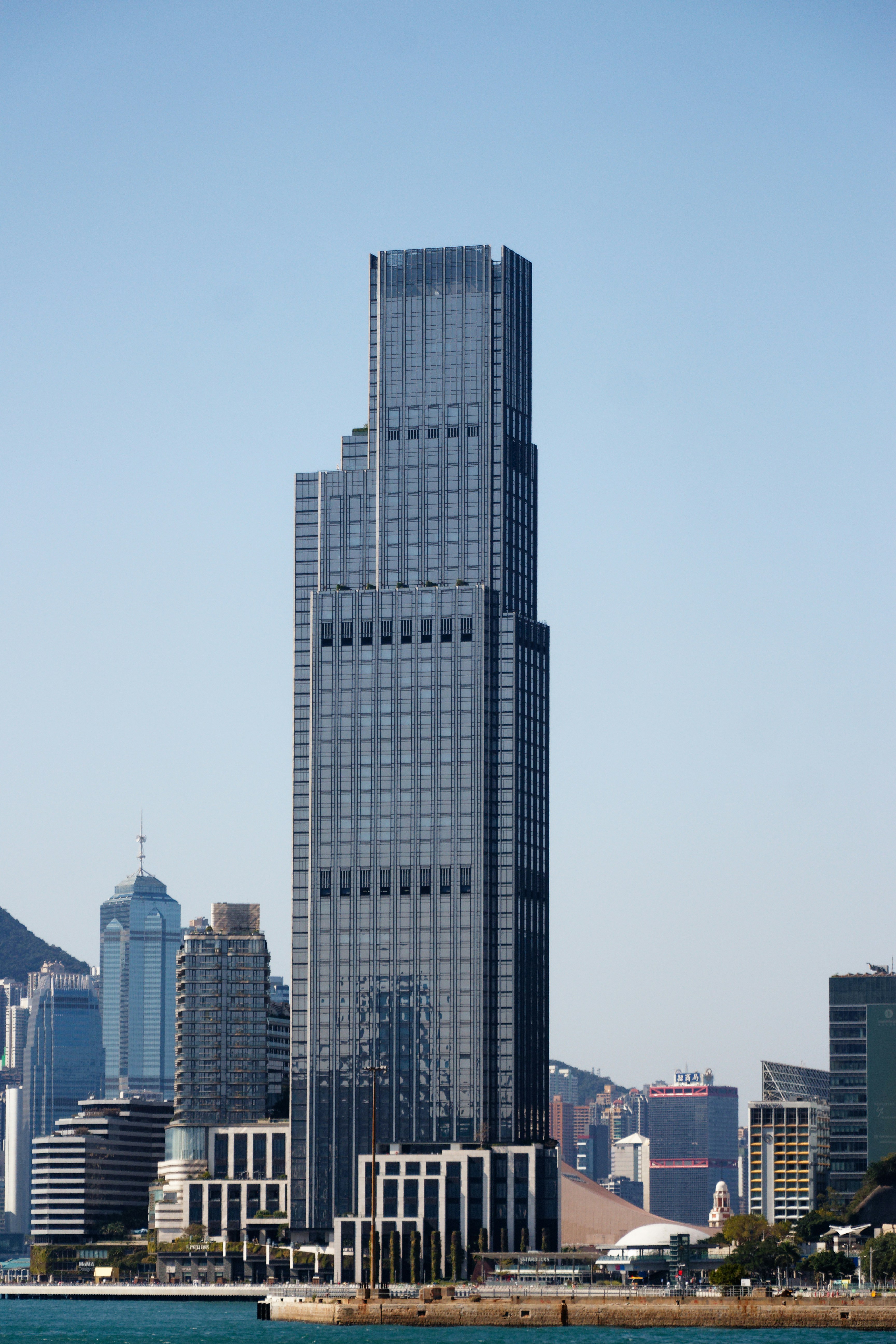 A very tall building in the middle of a large body of water photo ...