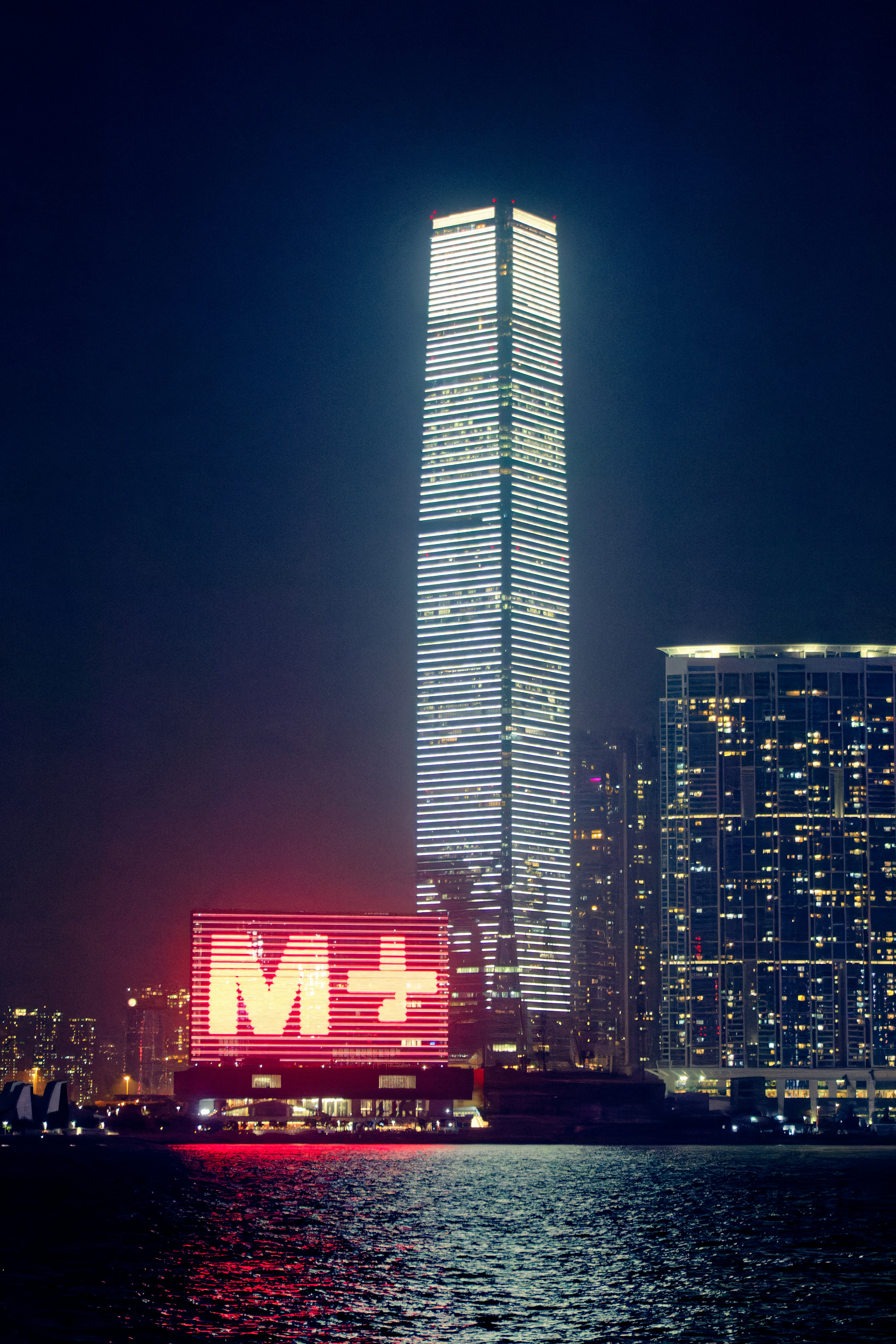 a very tall building with a sign in front of it
