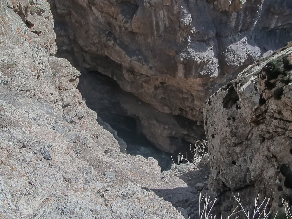a rocky cliff with a hole in the middle of it