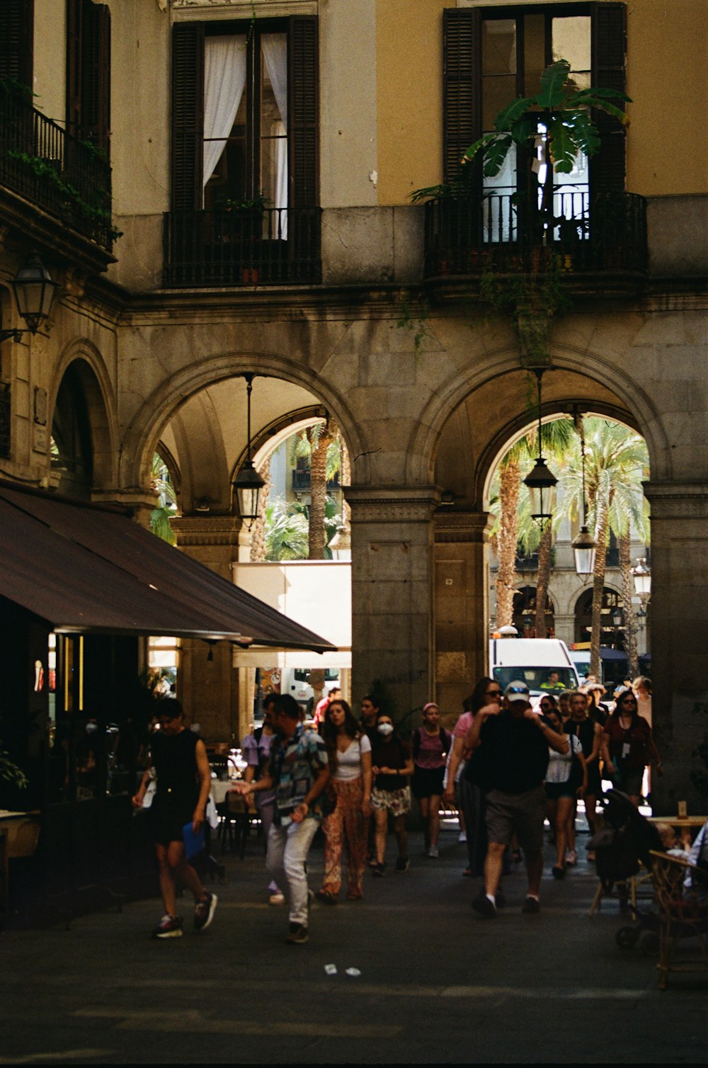 a group of people walking around a building