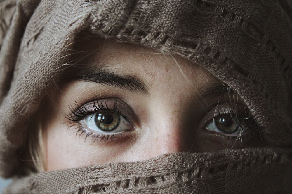 a close up of a person wearing a scarf