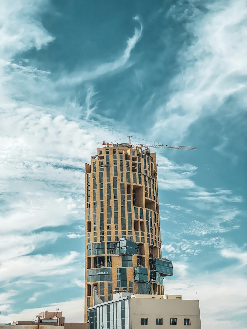 a tall building under a cloudy blue sky