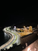 Night view of a car driving along Batam’s illuminated waterfront road.