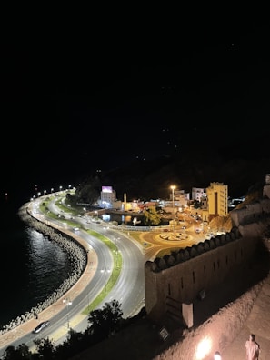 Night view of a car driving along Batam’s illuminated waterfront road.