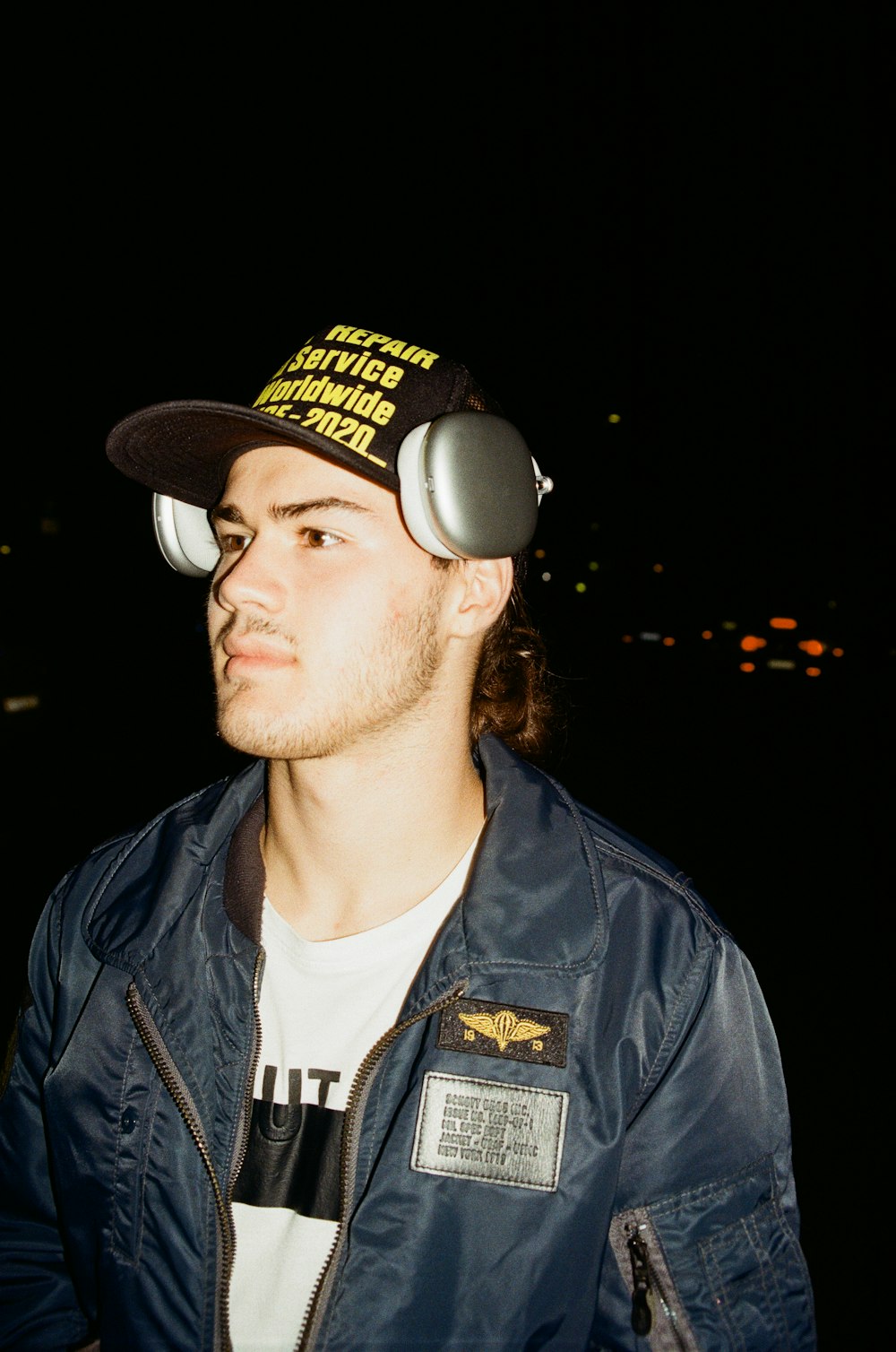 a man wearing a hat with headphones on his ears