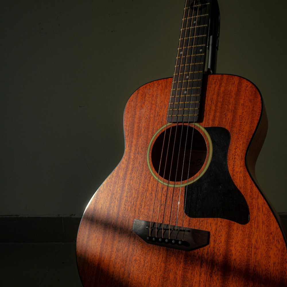 a close up of a guitar with a light shining on it