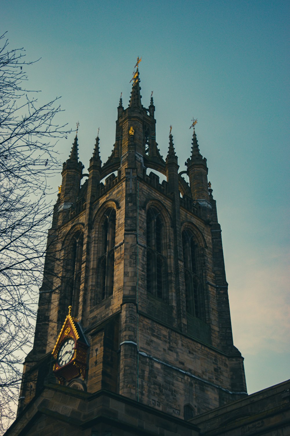 a tall clock tower with a clock on each of it's sides