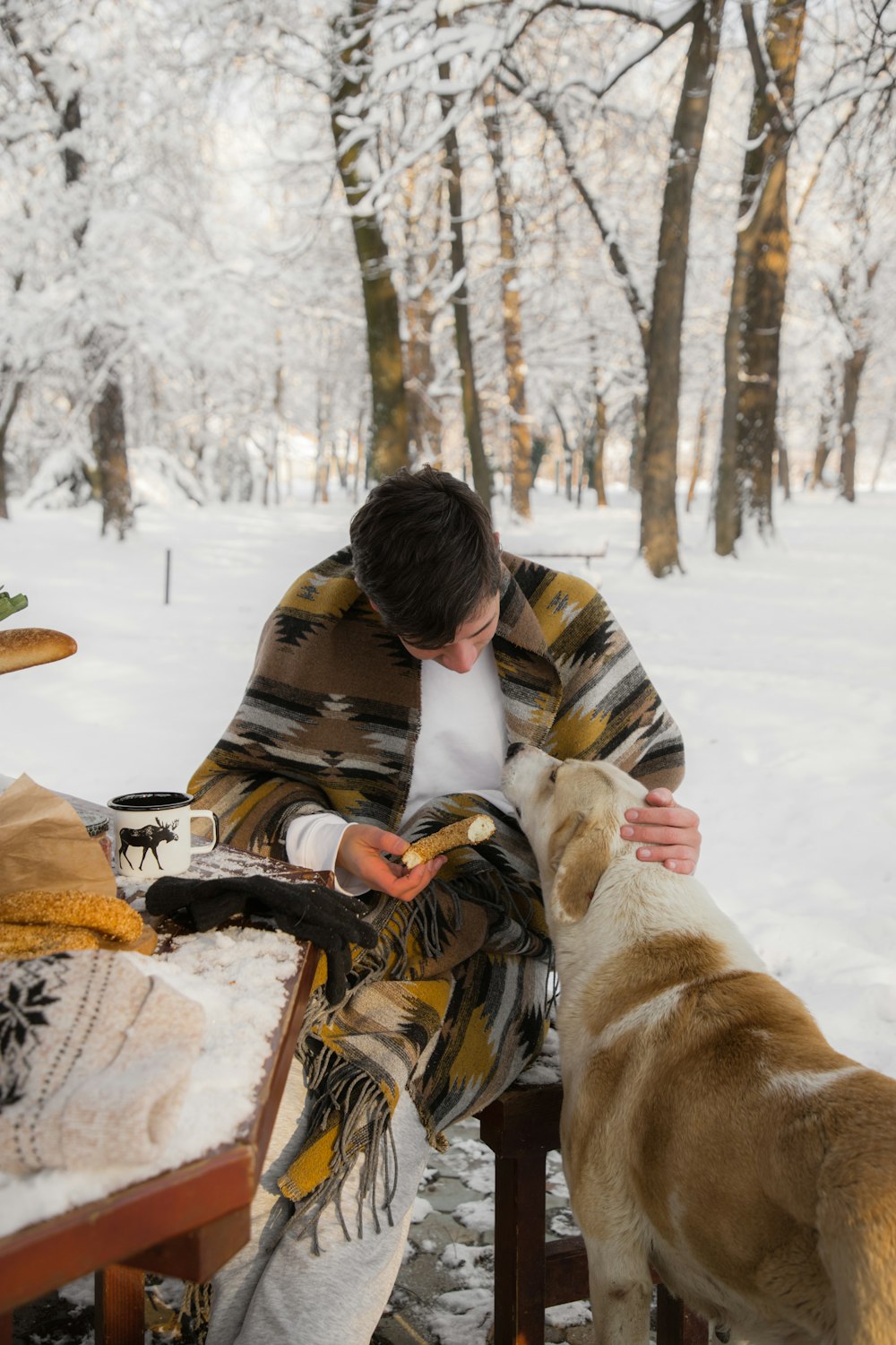 a man sitting on a bench next to a dog