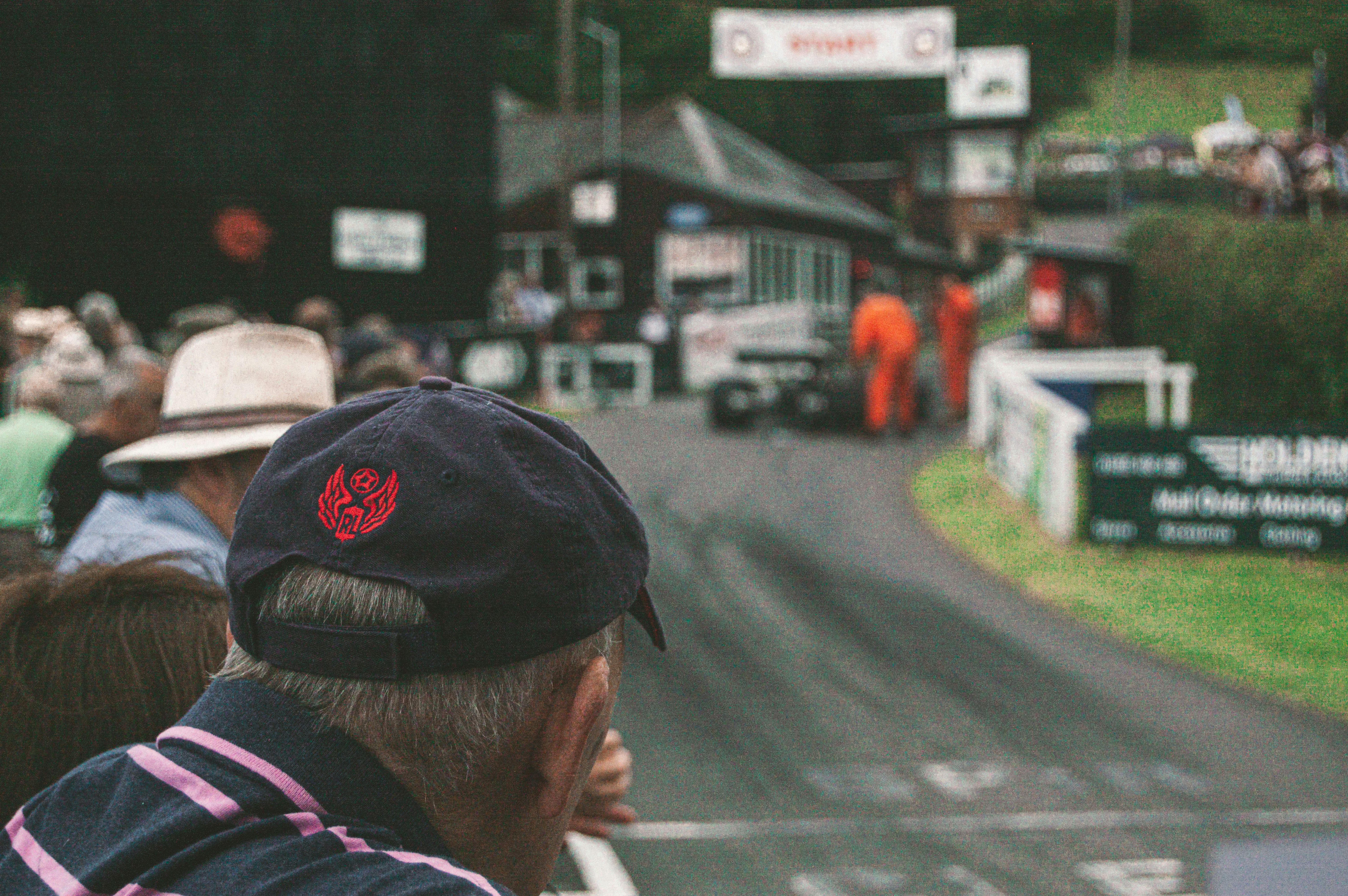 a group of people watching a race on a track