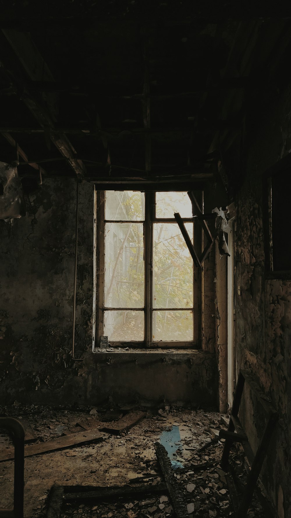 a run down room with a broken window