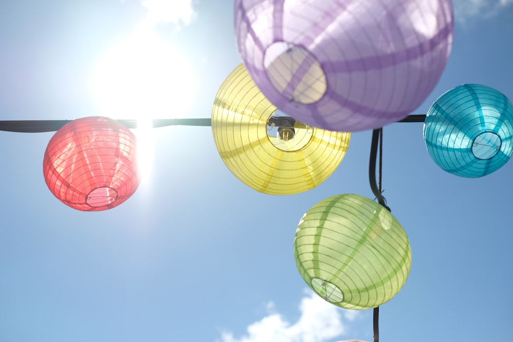 a bunch of colorful lanterns hanging from a line
