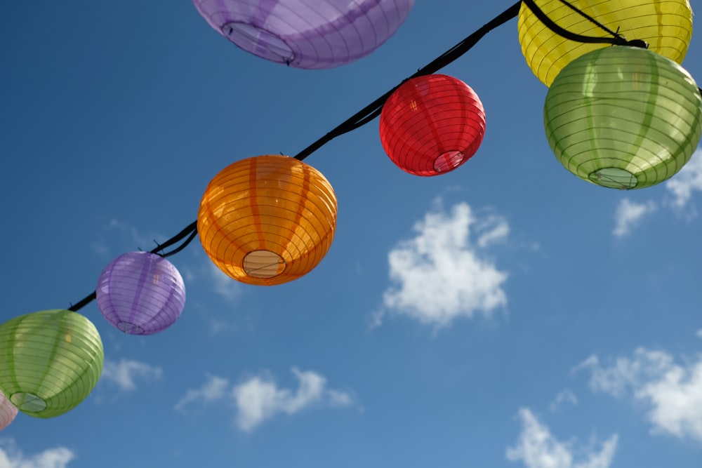 a bunch of lanterns hanging from a line