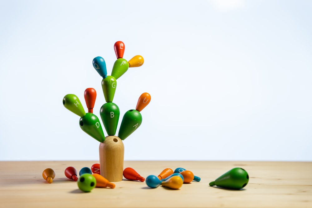 a wooden table topped with lots of colorful toys