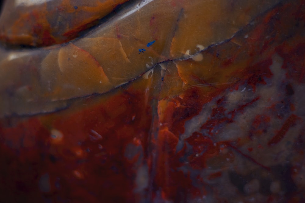 a close up of a red and yellow vase