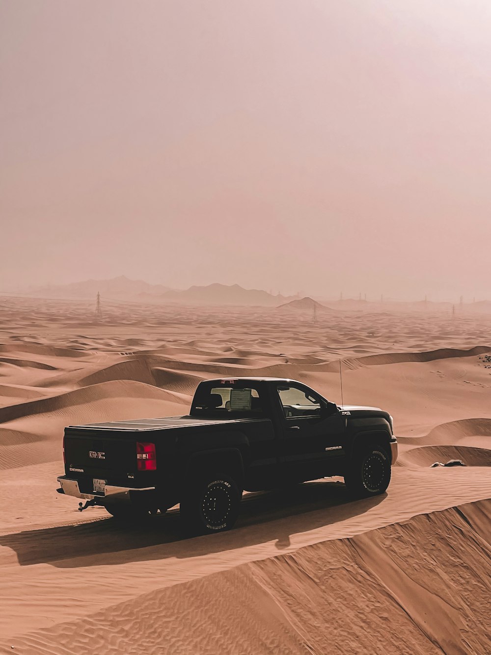 a truck is parked in the middle of a desert