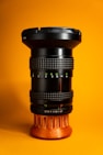 a close up of a camera lens on a yellow background