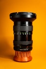 a close up of a camera lens on a yellow background