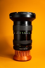 a close up of a camera lens on a yellow background