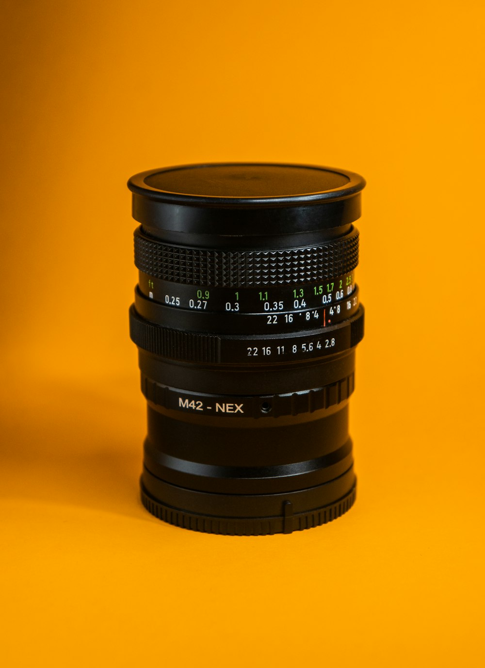 a close up of a camera lens on a yellow background