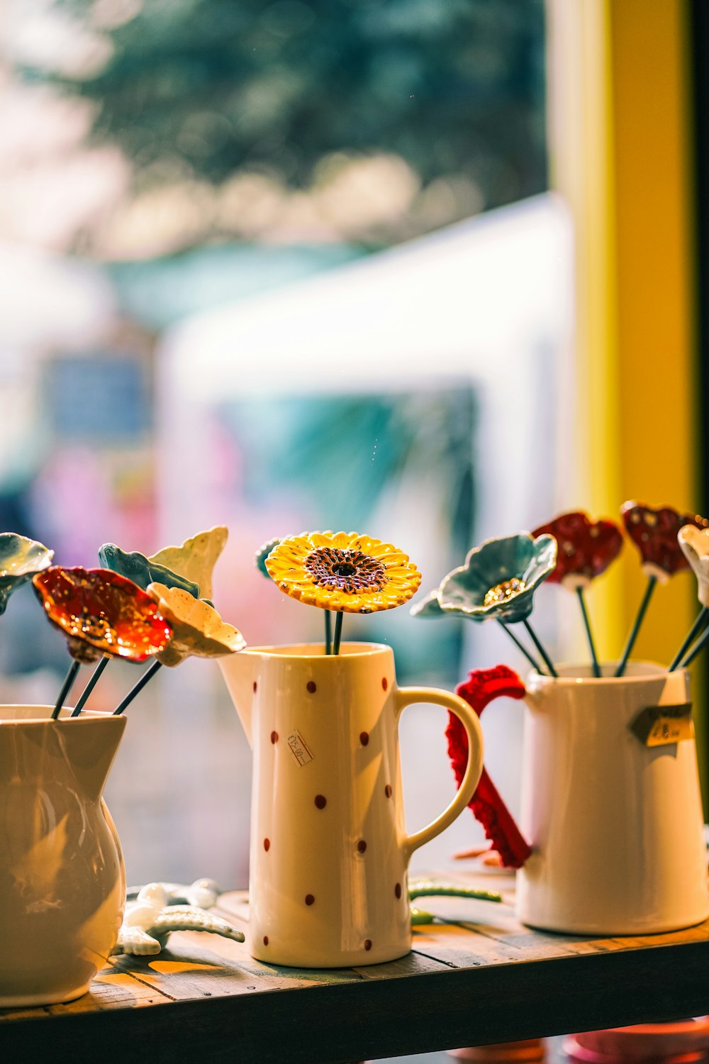 a couple of vases filled with flowers on top of a table