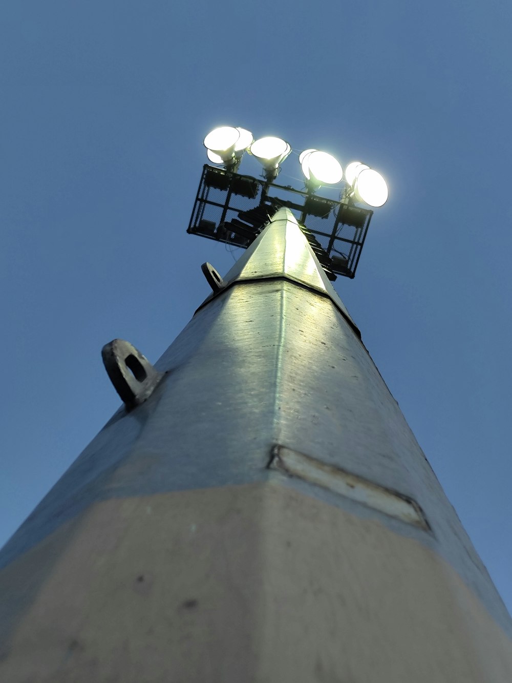 a tall light tower with four lights on top
