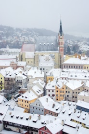 a view of a snowy city with a clock tower