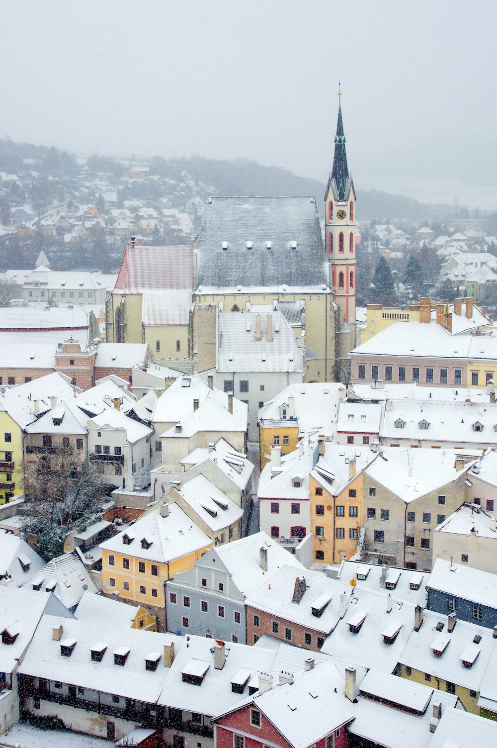 a view of a snowy city with a clock tower