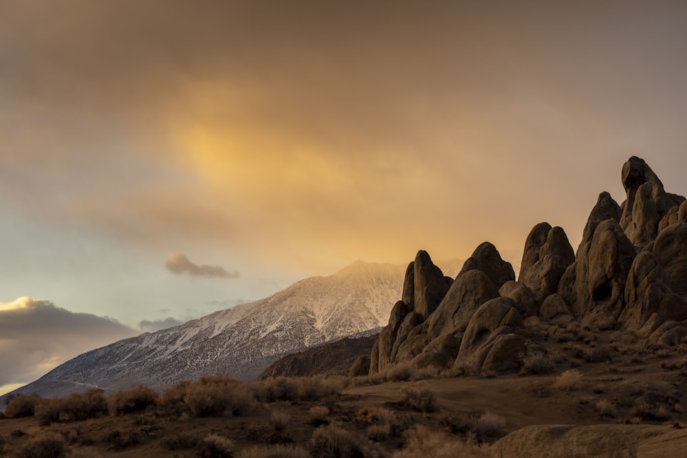 a mountain range with snow capped mountains in the background