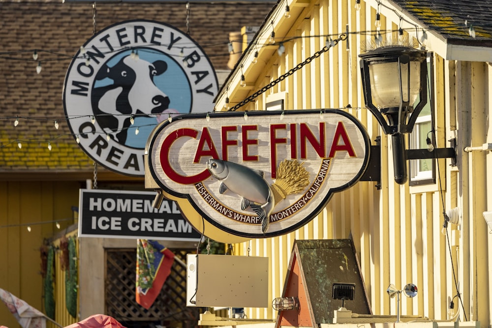 a restaurant sign hanging from the side of a building