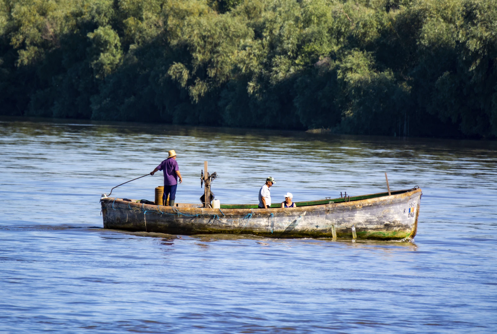 a man and two children in a boat on the water