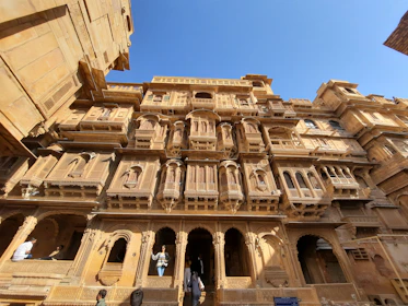 a tall building with many balconies on it