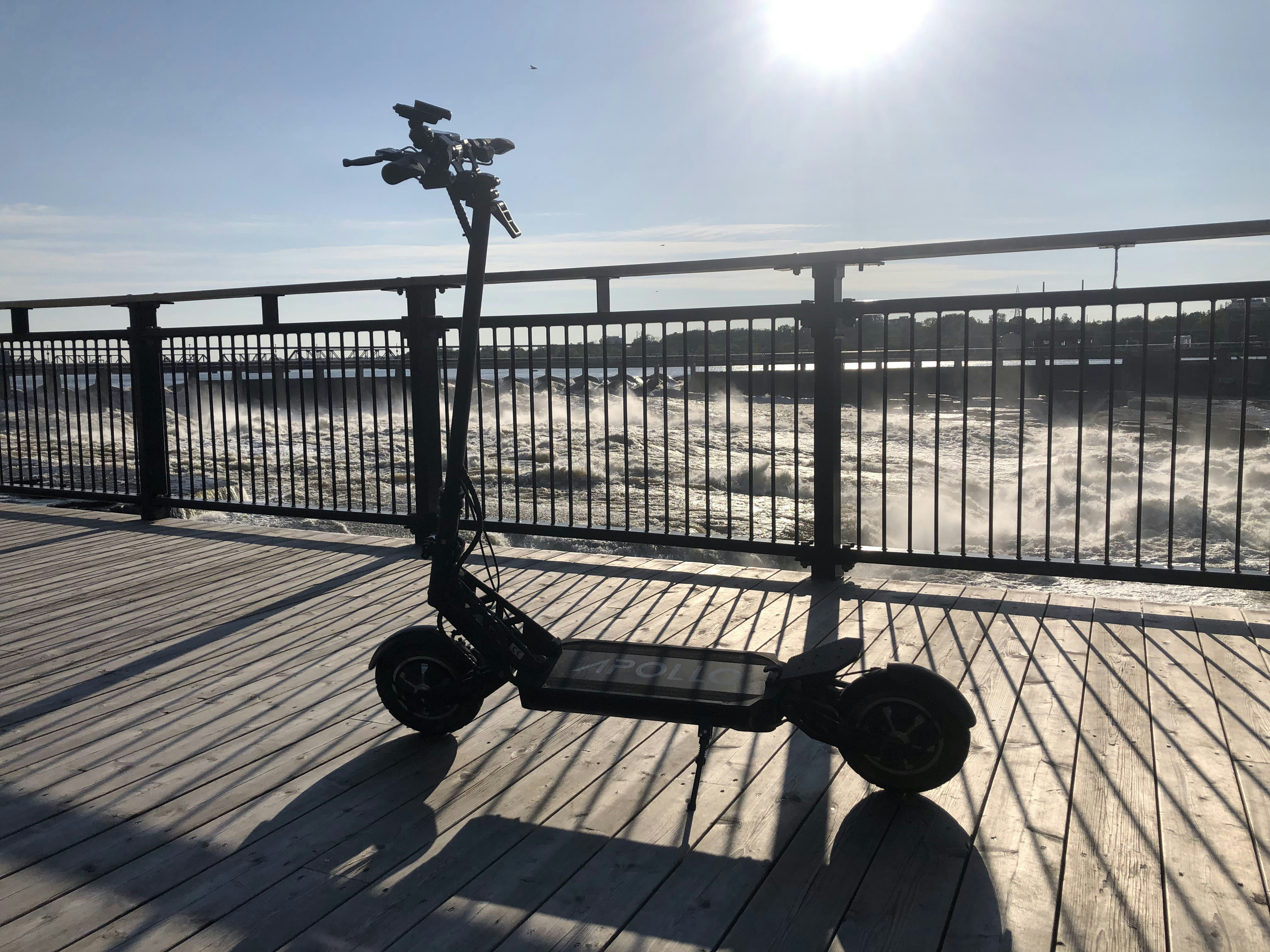 a scooter is parked on a wooden deck