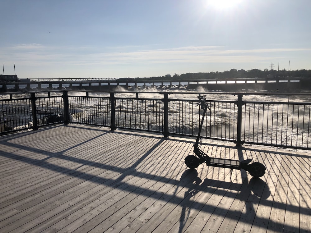 a scooter is parked on a wooden deck