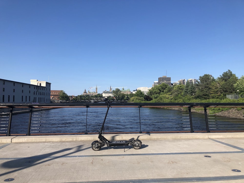 a scooter is parked on the side of a bridge
