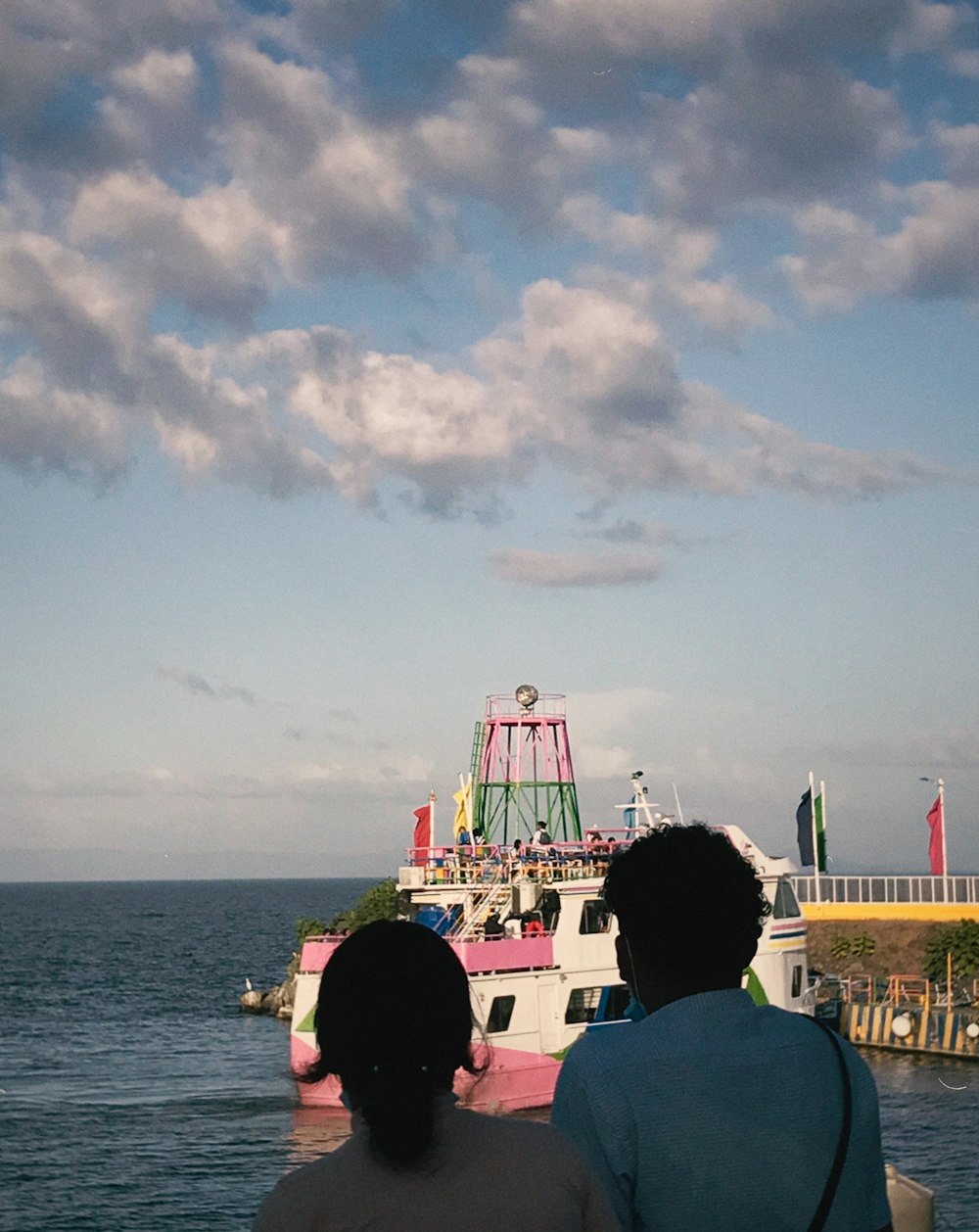 a couple of people that are looking at a boat