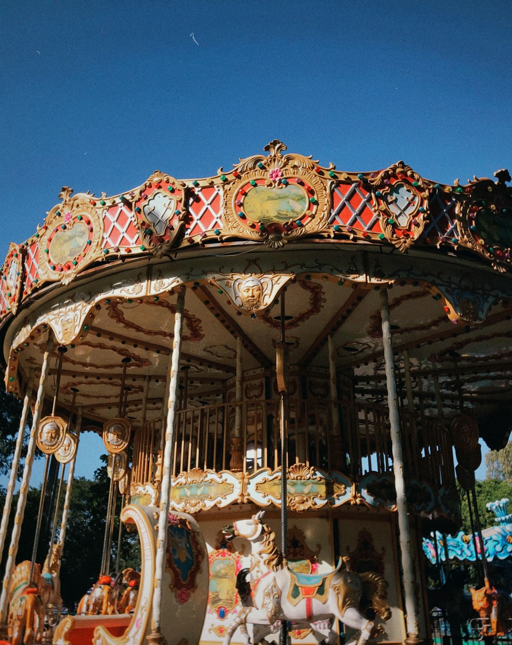 a merry go round with horses on a sunny day