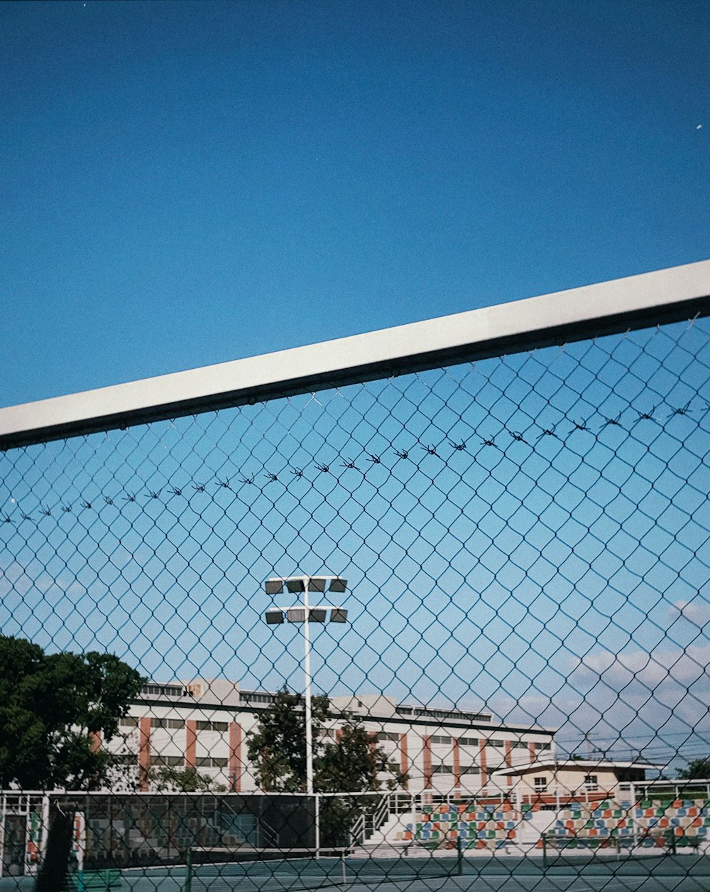 a tennis court with a building in the background