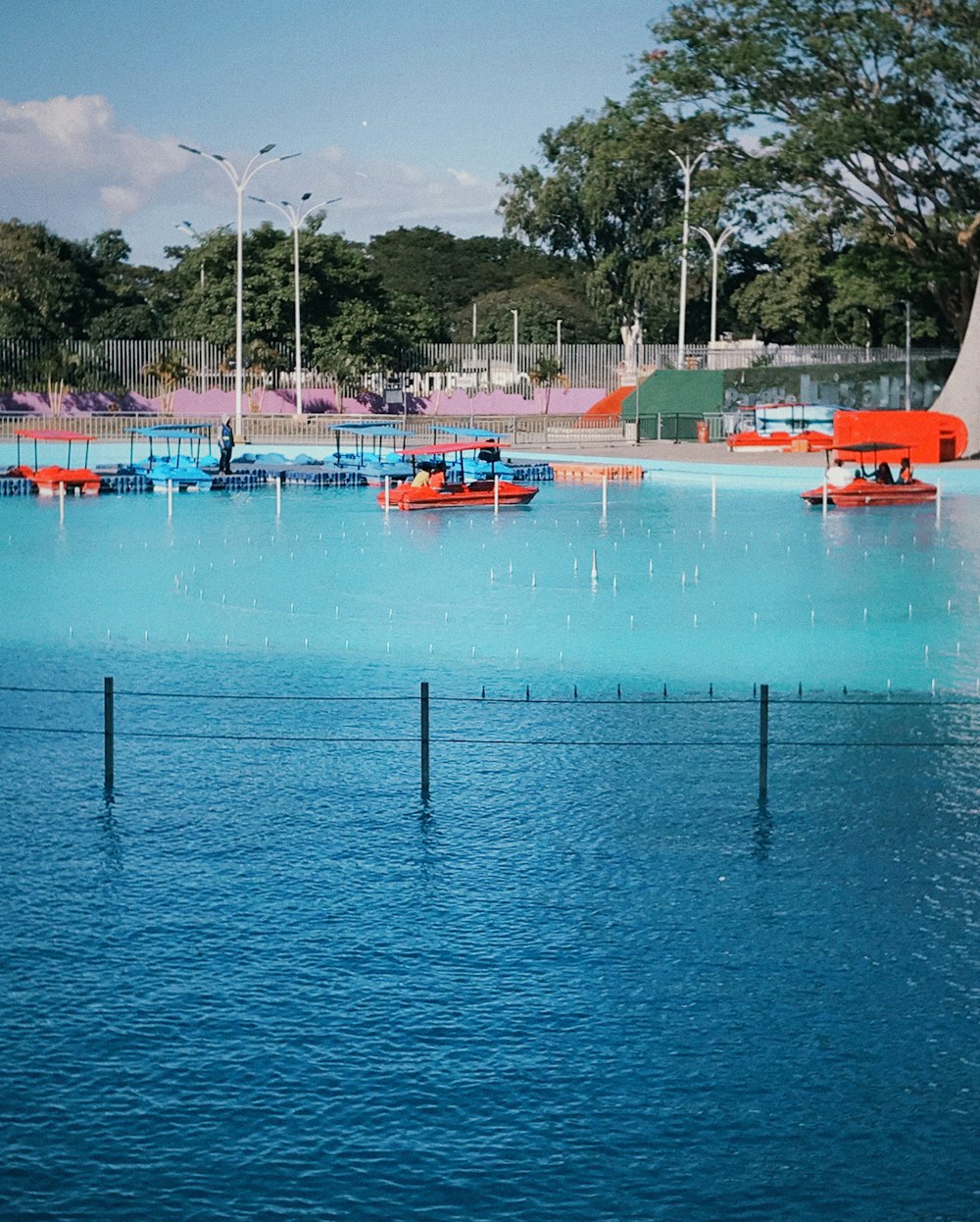 a large body of water with a playground in the background