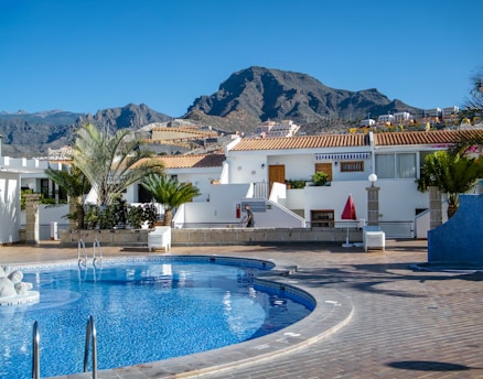 a swimming pool with a mountain in the background