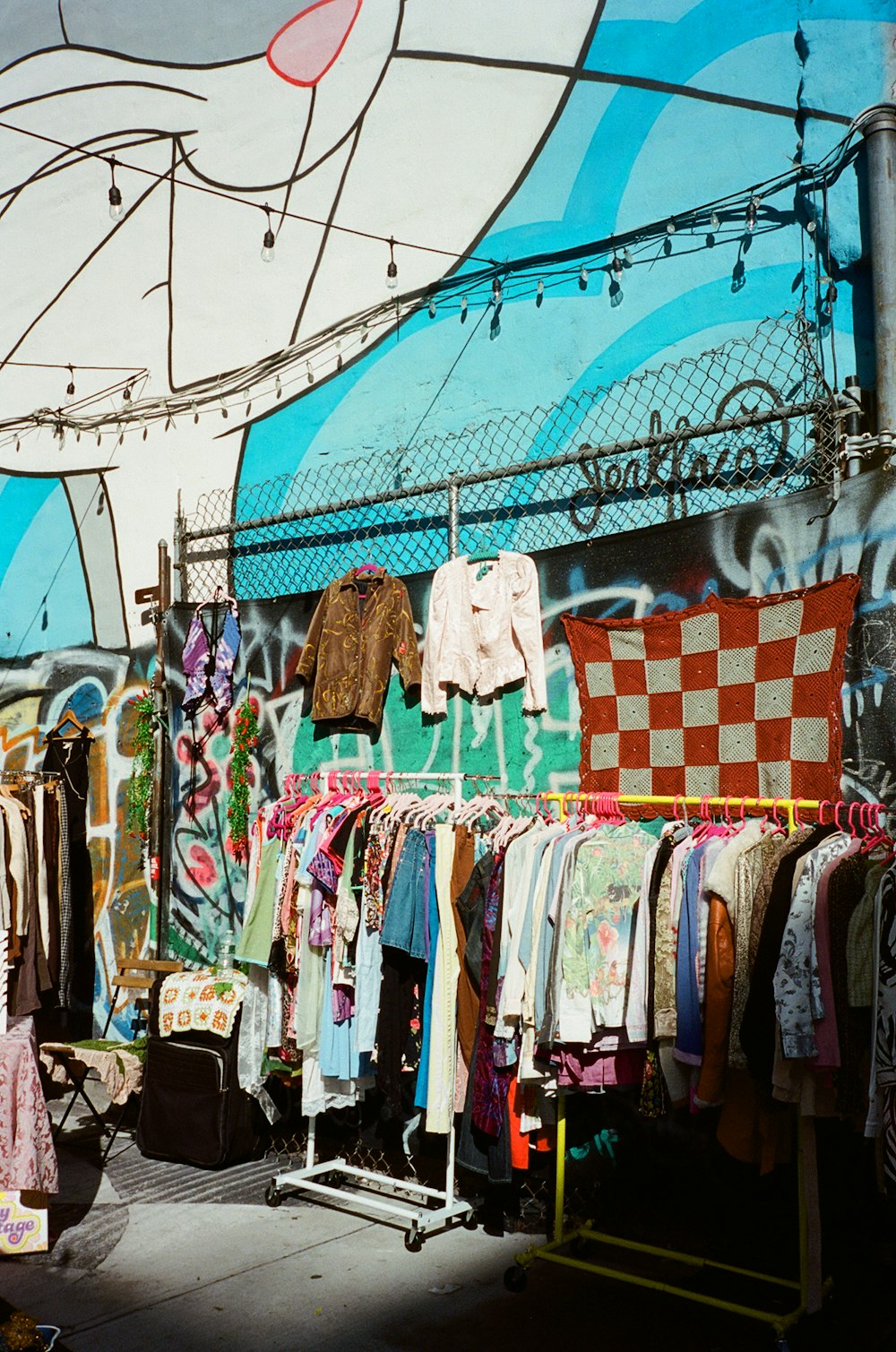 a bunch of clothes that are on a rack