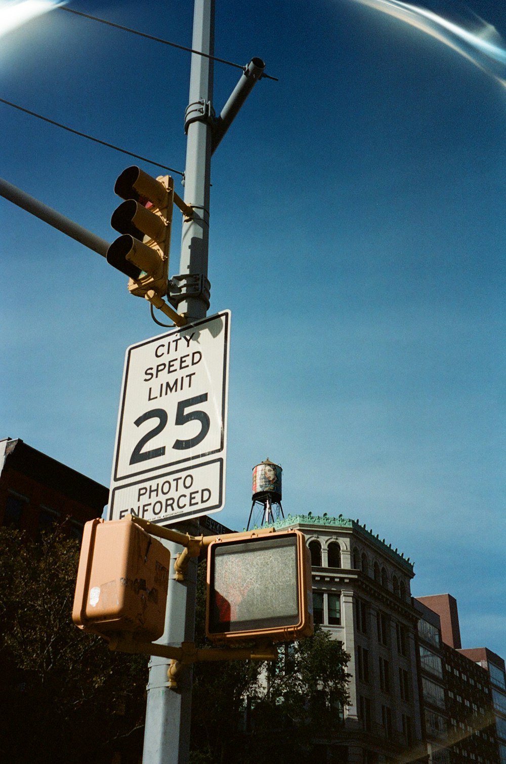 a traffic light with a speed limit sign on it