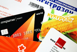 A stack of colorful credit cards fanned out on a wooden table.