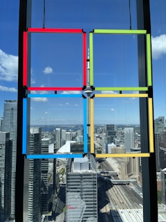 A vibrant cityscape view from a high-rise apartment window.