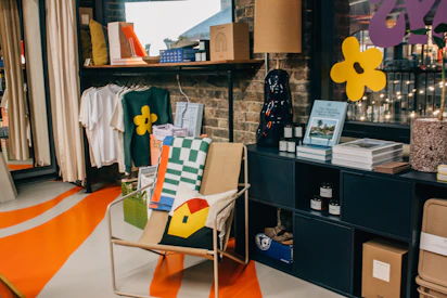 A cozy corner featuring folded hoodies, crewnecks, and hats, blending modern comfort with tradition.