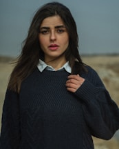 a woman with long hair wearing a sweater